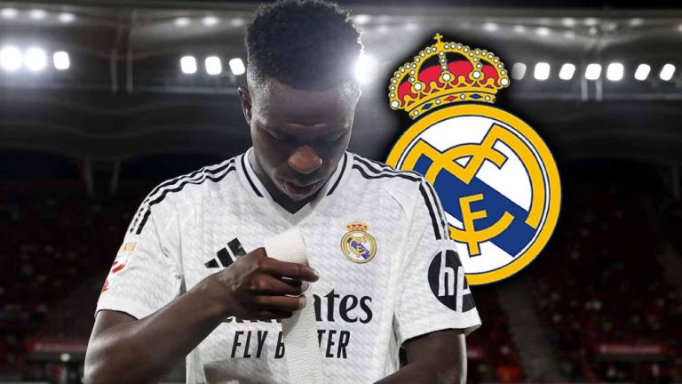 Vinicius serio con escudo RM