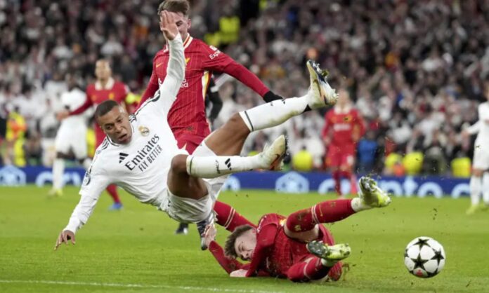Conor Bradley, abordando a Kylian Mbappe durante el partido de Champions del pasado curso entre el Liverpool y el Real Madrid en Anfield.