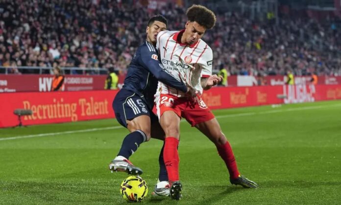 Jude Bellingham, en una acción del partido entre el Girona y el Real Madrid, chocando Axel Witsel.